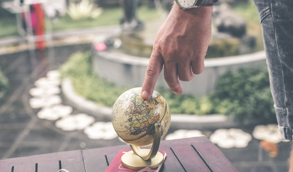 Image of a hand touching a globe