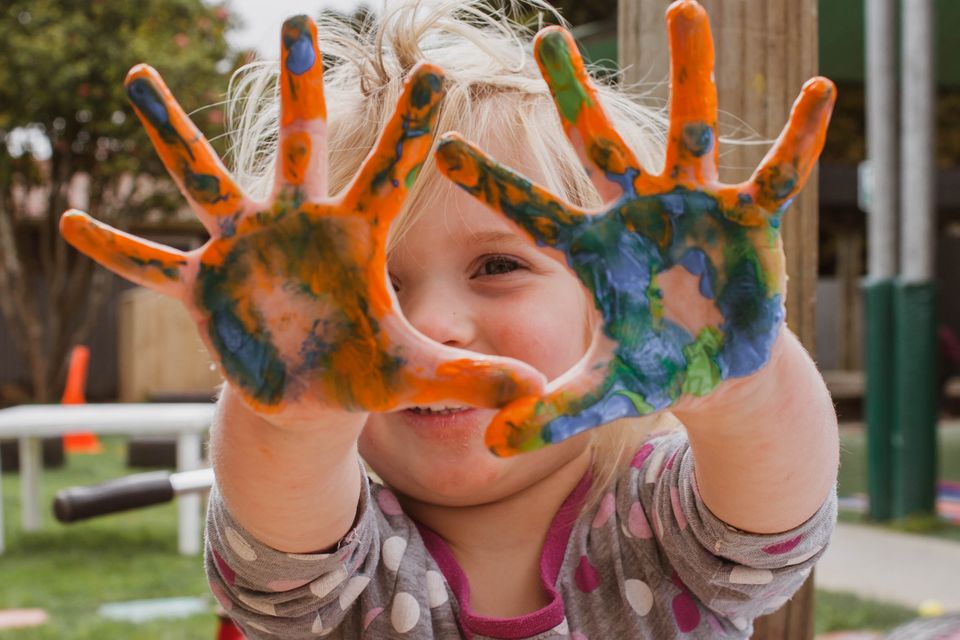 Child with painted hands.