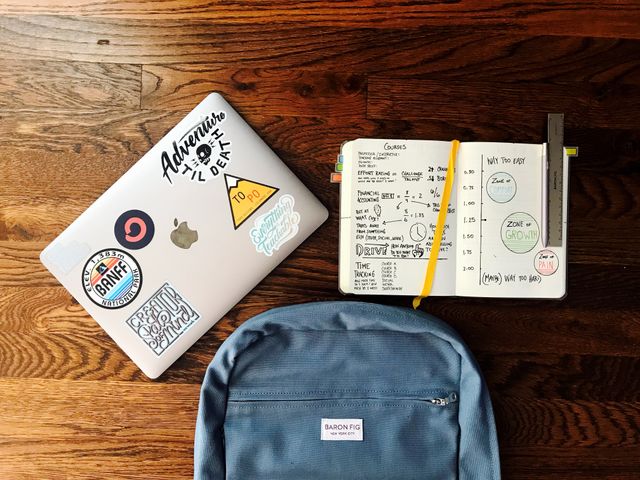 laptop and backpack on school desk