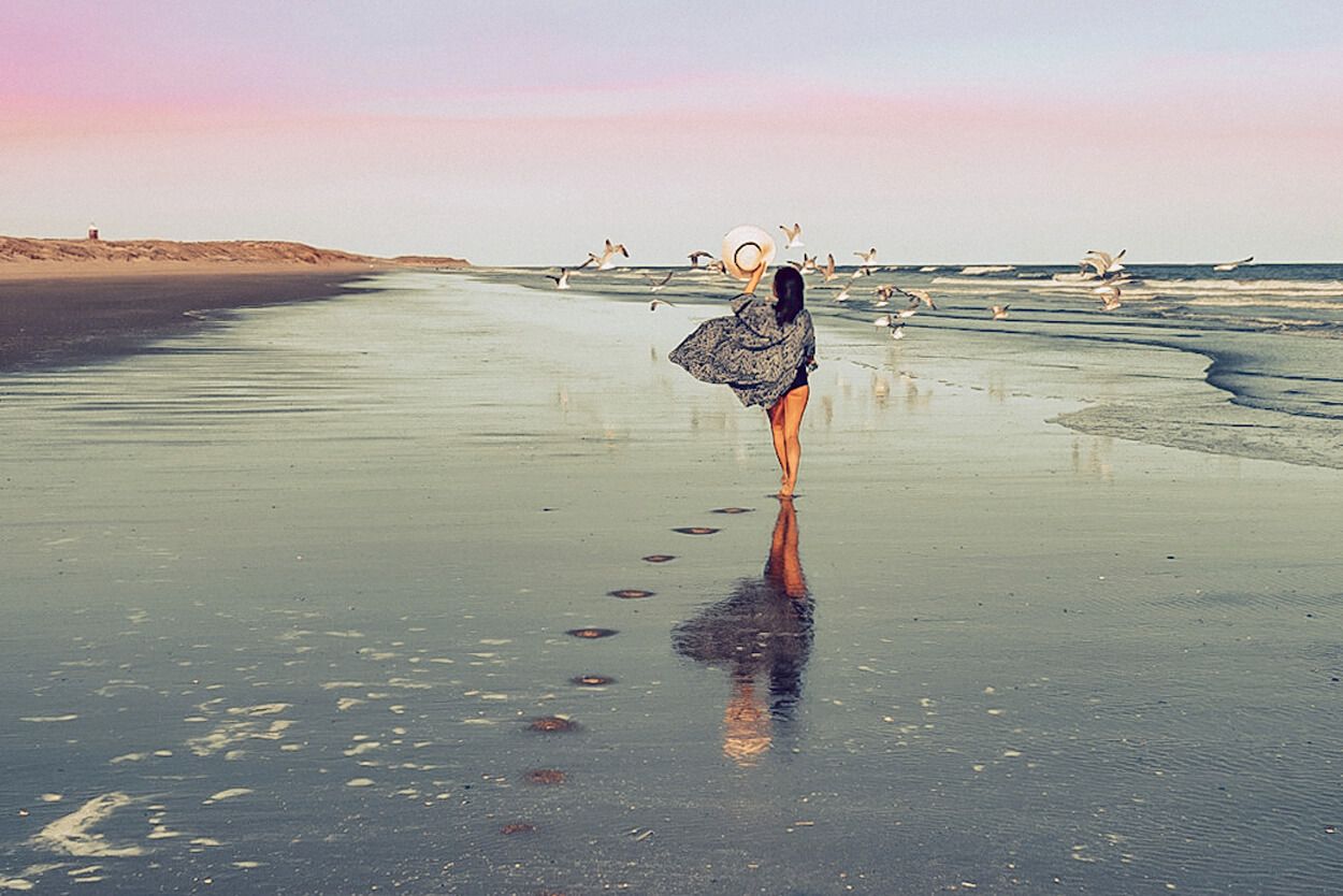 hippe vrouw flaneert over het strand