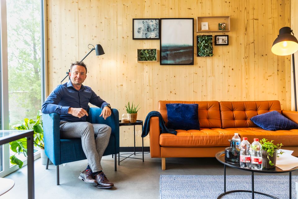 Een man in een stoel in de woonkamer van een startblock woning in Flevoland