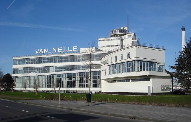 Het gebouw langs een weg, met de letters Van Nelle Fabriek bovenop het gebouw.