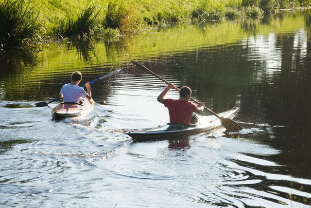Twee jongens varen met hun kajak door het water