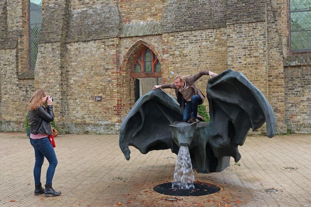 een man poseert op de vleermuis fontein in bolsward